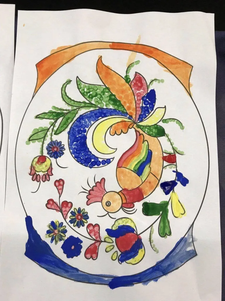 A Petrykivka folk painting — a bird among flowers in blue, orange and green.