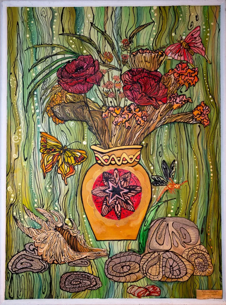 A batik painting of a vase of flowers with butterflies, made at a children's art class.