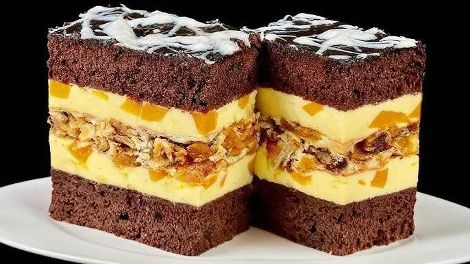 Two slices of chocolate sponge cake layered with cream.
