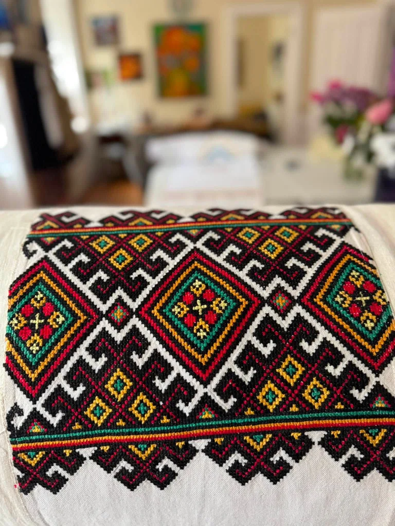 Geometric cross-stitch in red, gold and black on heavy linen